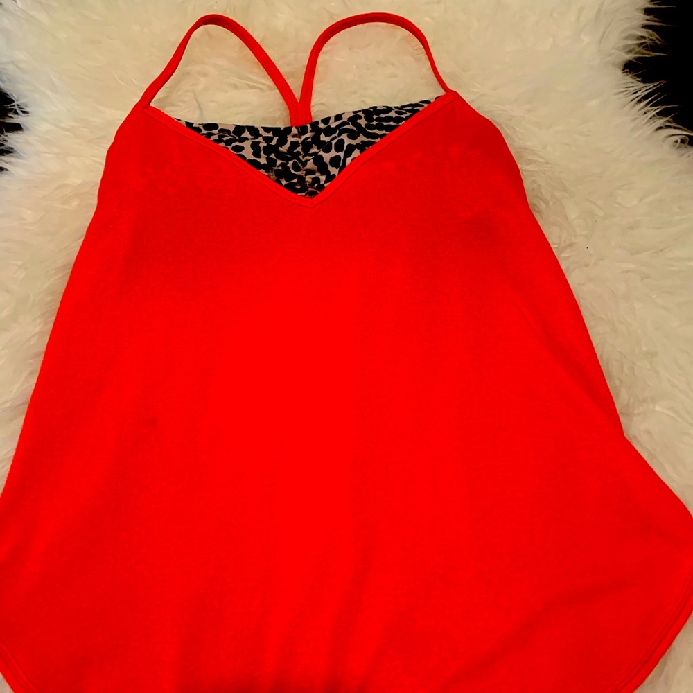 Bright Lululemon coral tank with attached animal print sport bra